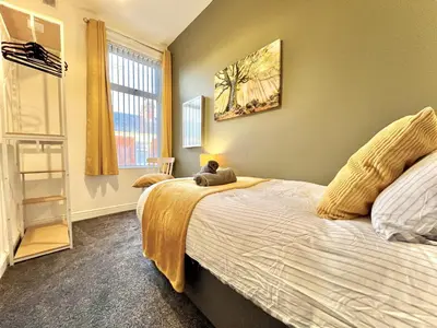 a bedroom with a bed with a cat sitting on it at Ideal 4-bed stay-away-home sleeps 6 in Preston in Preston