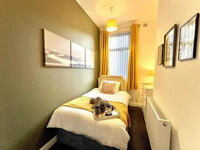 a small room with two twin beds in it at Ideal 4-bed stay-away-home sleeps 6 in Preston in Preston