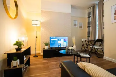a living room with a couch and a tv at Silvester Residence in Liverpool