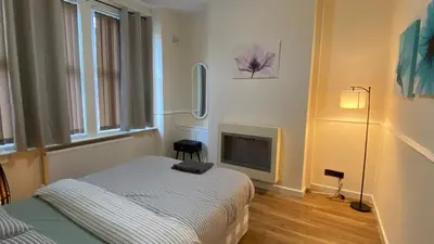 a bedroom with a bed and a fireplace at Silvester Residence in Liverpool