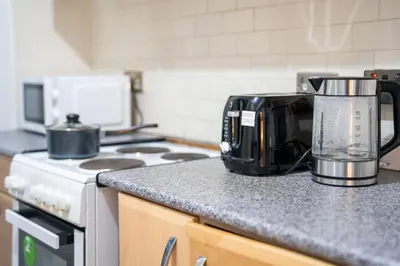 a kitchen with a counter top with a toaster and a appliance at Silvester Residence in Liverpool