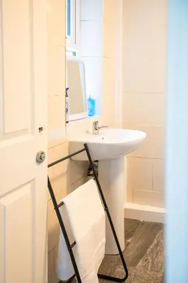a bathroom with a sink and a mirror at Silvester Residence in Liverpool