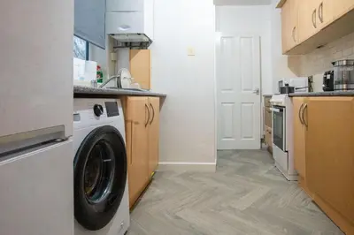 a kitchen with a washing machine in a kitchen at Silvester Residence in Liverpool