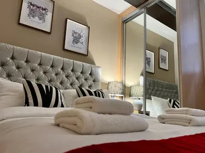 a bedroom with a large bed with towels on it at Beautiful City Centre 2 Bedroomed Apartment in Liverpool