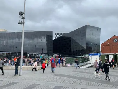 a group of people walking in a plaza with buildings at Beautiful City Centre 2 Bedroomed Apartment in Liverpool