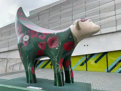 a statue of a cow with red flowers on it at Beautiful City Centre 2 Bedroomed Apartment in Liverpool