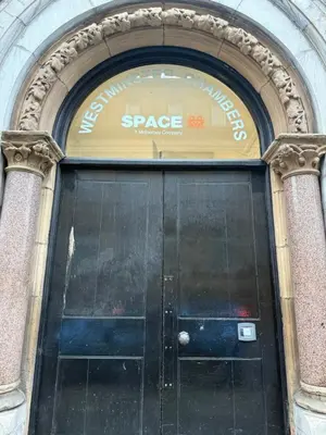 a door in a building with a sign on it at Beautiful City Centre 2 Bedroomed Apartment in Liverpool