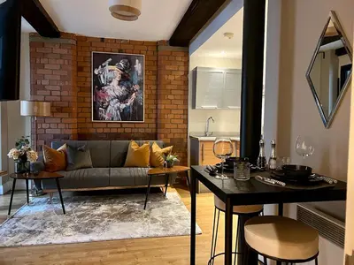 a living room with a couch and a table at Beautiful City Centre 2 Bedroomed Apartment in Liverpool