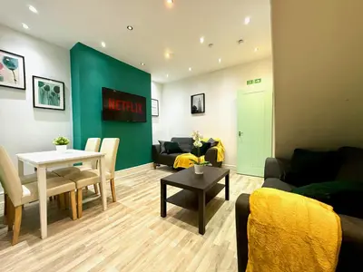 a living room with a couch and a table at Liverpool Serviced Apartment - Mallow in Liverpool