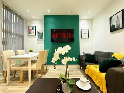 a living room with a couch and a table at Liverpool Serviced Apartment - Mallow in Liverpool