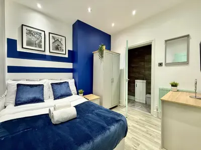 a blue and white bedroom with a large bed at Liverpool Serviced Apartment - Mallow in Liverpool