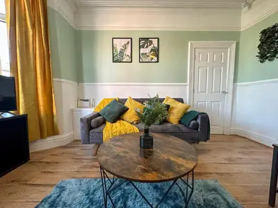 a living room with a couch and a table at Liverpool Serviced Apartment - Phillimore in Liverpool