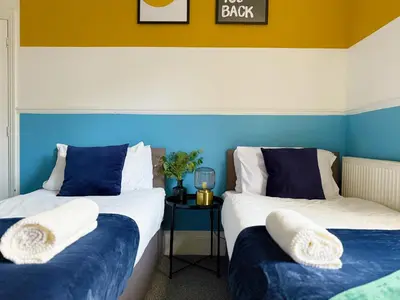two beds in a room with blue and white at Liverpool Serviced Apartment - Phillimore in Liverpool