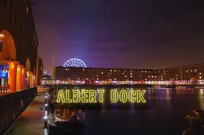 a sign that reads alert dock on a river at night at Liverpool Serviced Apartment - Phillimore in Liverpool