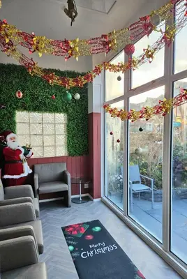 a waiting room with christmas decorations and a christmas rug at Hotel Claytou in Blackpool