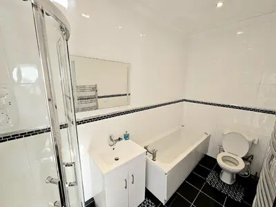 a bathroom with a sink and a toilet and a bath tub at Hotel Claytou in Blackpool