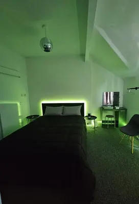 a bedroom with a bed and a table and chairs at Hotel Claytou in Blackpool