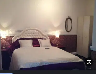 a bedroom with a white bed and a mirror at Number 10 in Blackpool