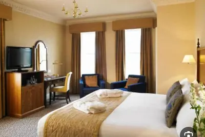 a hotel room with a bed and a desk and a television at Number 10 in Blackpool