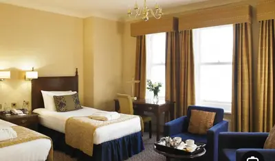 a hotel room with a bed and a chair at Number 10 in Blackpool