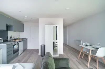 a kitchen and living room with a couch and a table at Fabulous Studio in Central Liverpool in Liverpool