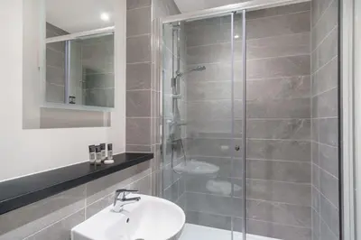 a bathroom with a shower with a sink and a toilet at Fabulous Studio in Central Liverpool in Liverpool