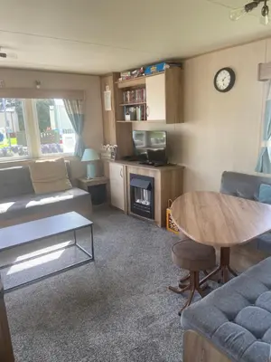 a living room with a couch and a table at Haven Lakeland Caravan Hire in the Lake District in Flookburgh