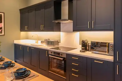 a kitchen with black cabinets and a counter top at Host & Stay - The Georgian Quarter at Catharine House in Liverpool