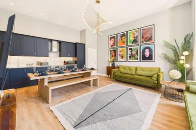 a living room with a green couch and a kitchen at Host & Stay - The Georgian Quarter at Catharine House in Liverpool