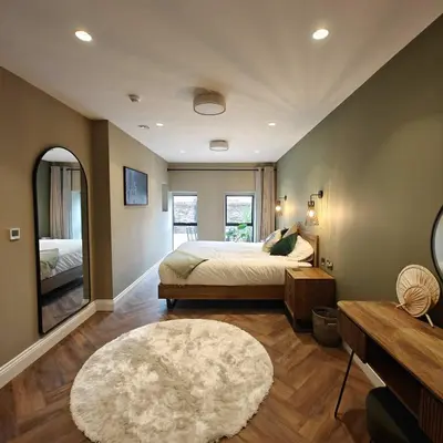 a large bedroom with a bed and a rug at The Basement in Saint Annes on the Sea