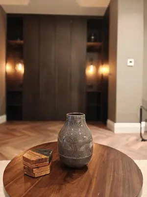 a vase sitting on top of a wooden table at The Basement in Saint Annes on the Sea