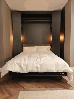 a bedroom with a large bed with white sheets at The Basement in Saint Annes on the Sea