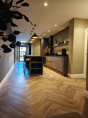 a kitchen with a counter and a table in a room at The Basement in Saint Annes on the Sea
