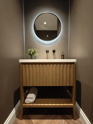 a bathroom with a sink and a mirror at The Basement in Saint Annes on the Sea