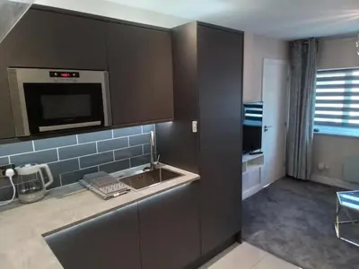 a kitchen with a sink and a microwave at Beachview apartment in Cleveleys