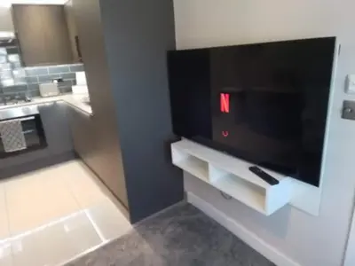 a kitchen with a large flat screen tv in a room at Beachview apartment in Cleveleys