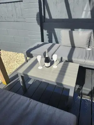 a bottle of wine sitting on a table with two glasses at Beachview apartment in Cleveleys