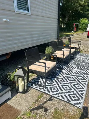 a group of chairs sitting next to a trailer at Hideaway Ribble Valley in Preston