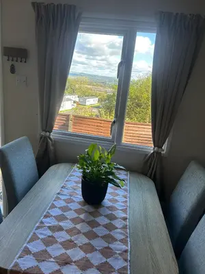 a table with a potted plant sitting on it in front of a window at Hideaway Ribble Valley in Preston
