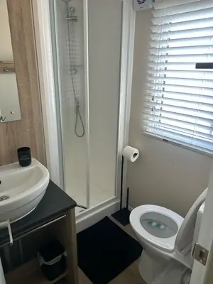 a bathroom with a toilet and a sink and a shower at Hideaway Ribble Valley in Preston