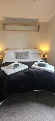 a bedroom with a bed with two towels on it at Hideaway Ribble Valley in Preston