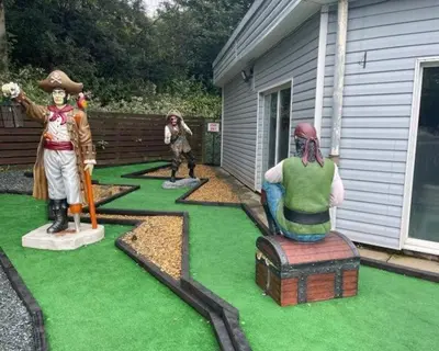 a garden with statues of people on the grass at Hideaway Ribble Valley in Preston