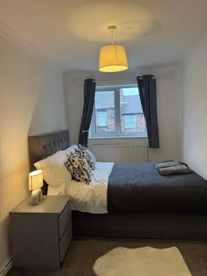 a bedroom with a bed and a window at Gertrude house in Saint Helens