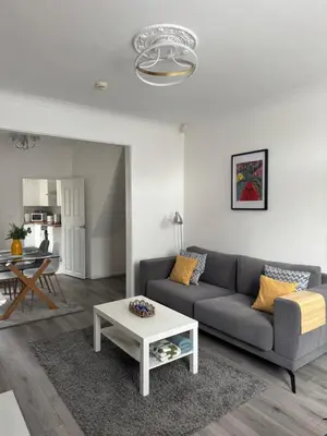 a living room with a couch and a table at Gertrude house in Saint Helens
