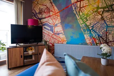 a living room with a tv and a map on the wall at City centre two bedroom apartment in the heart of Liverpool in Liverpool