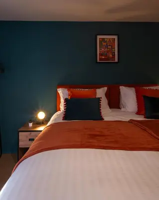 a bedroom with a large bed with red and white pillows at City centre two bedroom apartment in the heart of Liverpool in Liverpool