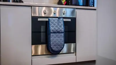 a tie hanging on the oven door of a stove at Central Warehouse Apt - Sleeps 8, Pet Friendly in Liverpool