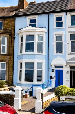 a blue house with a blue door on a street at Sunbeam House 1 Morecambe Pet Friendly in Morecambe