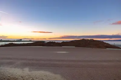 a view of a beach with the sunset in the background at Sunbeam House 1 Morecambe Pet Friendly in Morecambe