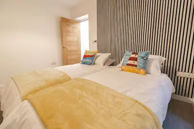a bedroom with a large white bed with pillows at Sunbeam House 1 Morecambe Pet Friendly in Morecambe